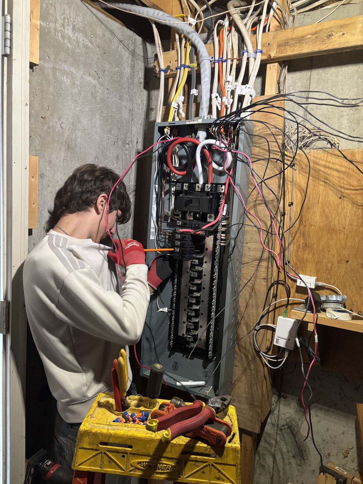 A. Pro Electric electrician landing conductors in the new breaker panel during the service upgrade