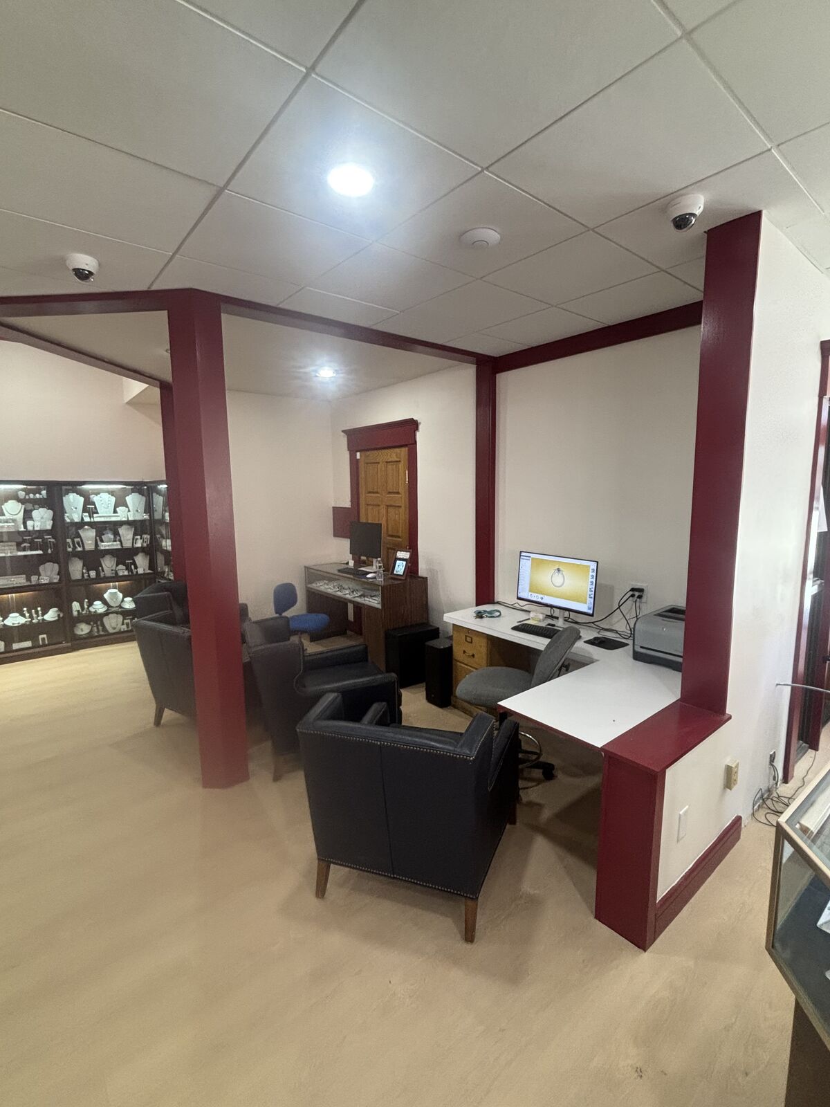 Consultation desk and seating under new recessed ceiling lights in the Concord jewelry store