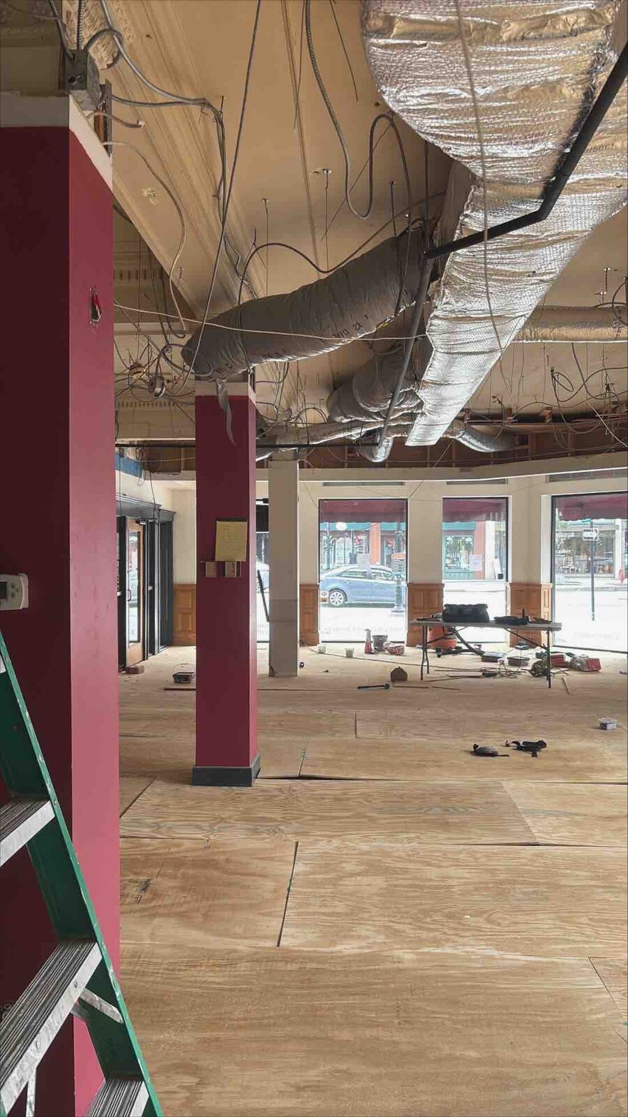 Before: the gutted Concord storefront with the ceiling open and old wiring hanging, ready for the jewelry store fit-up