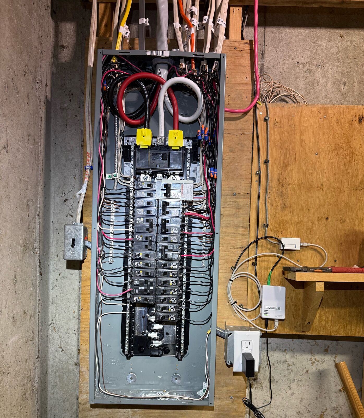 New breaker panel installed on a plywood backboard after the service upgrade in Deering, NH