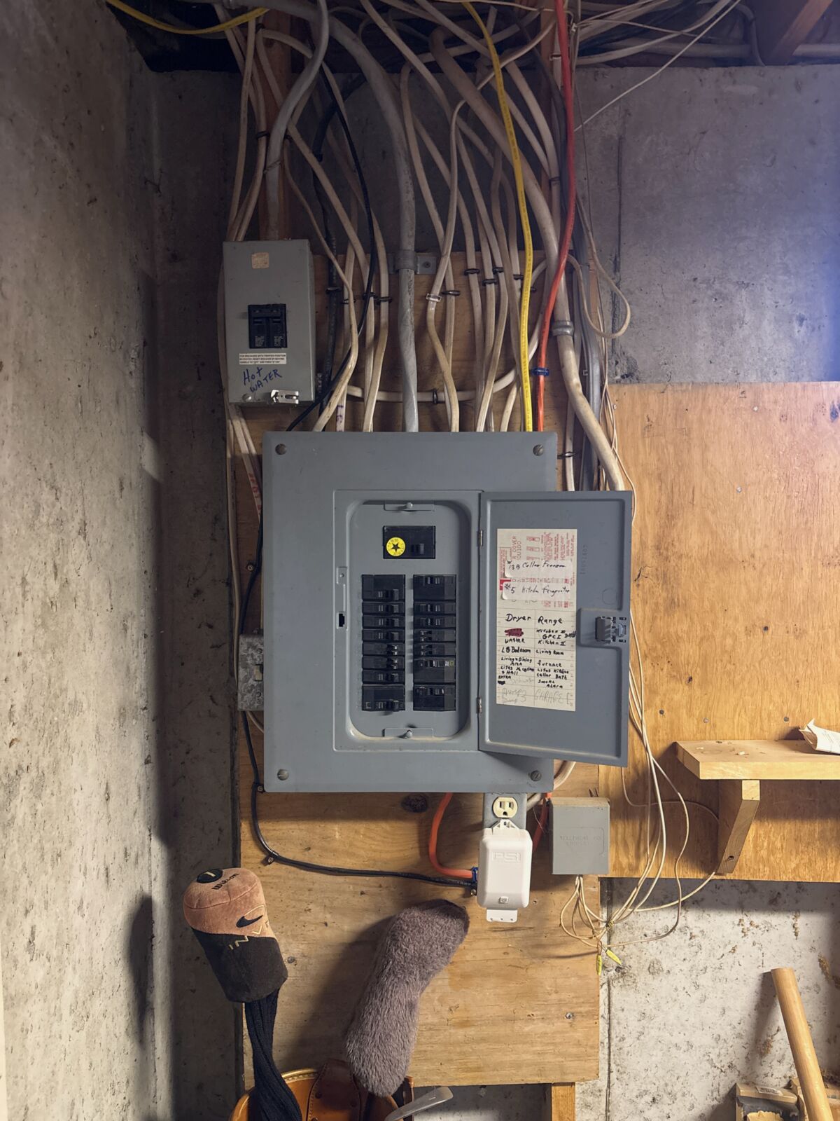 Before: the old breaker panel and crowded wiring on a basement wall in Deering, NH