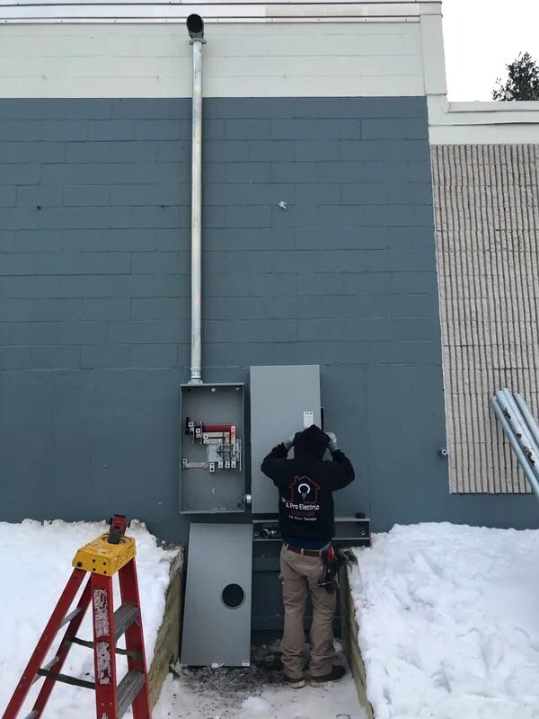 A. Pro Electric technician working in an open disconnect in winter