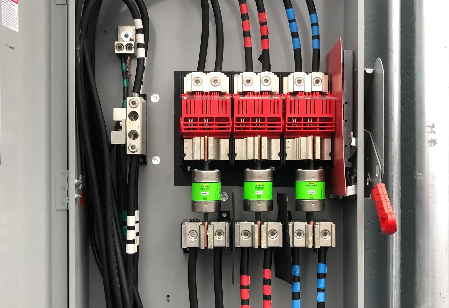 Fused disconnect with phase-taped conductors in a commercial panel