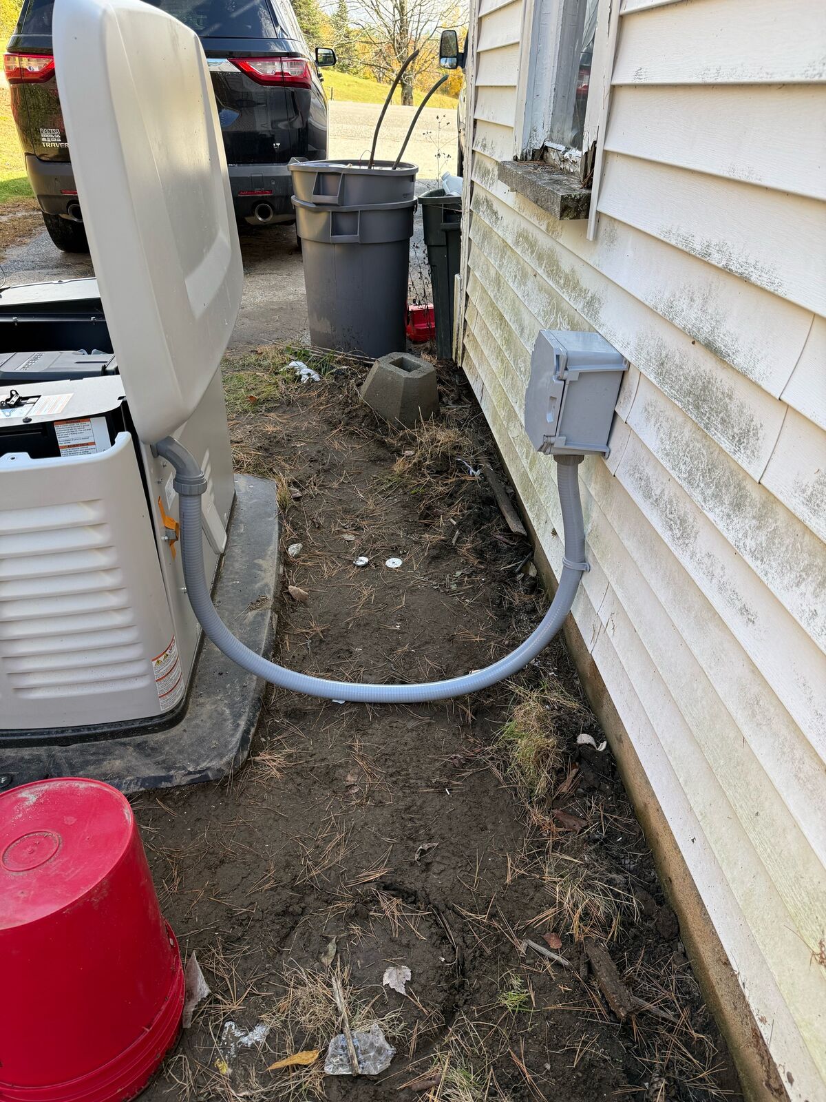 Standby generator on its pad with the conduit run from the unit to the house